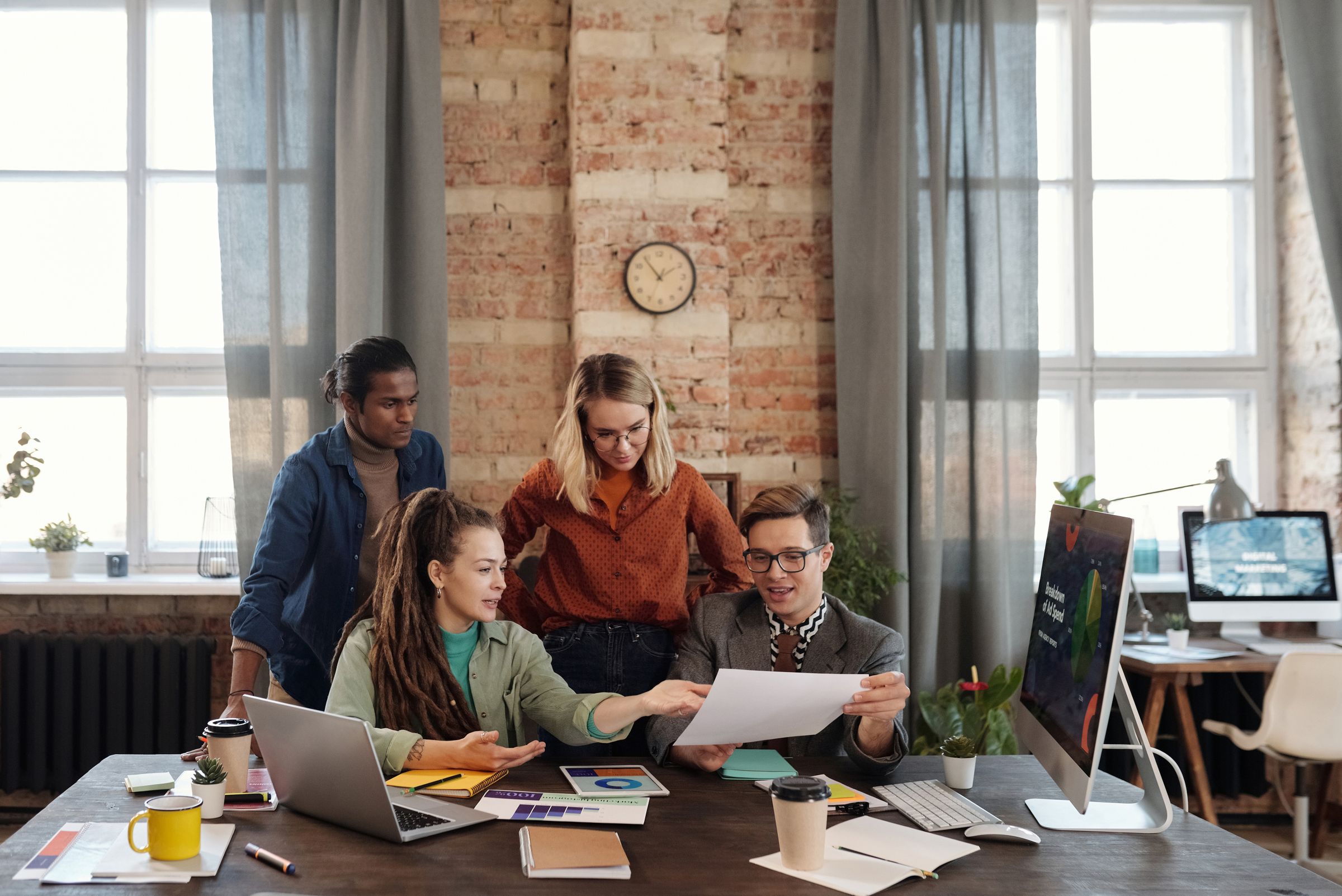 Marketing team working through a campaign plan around a table