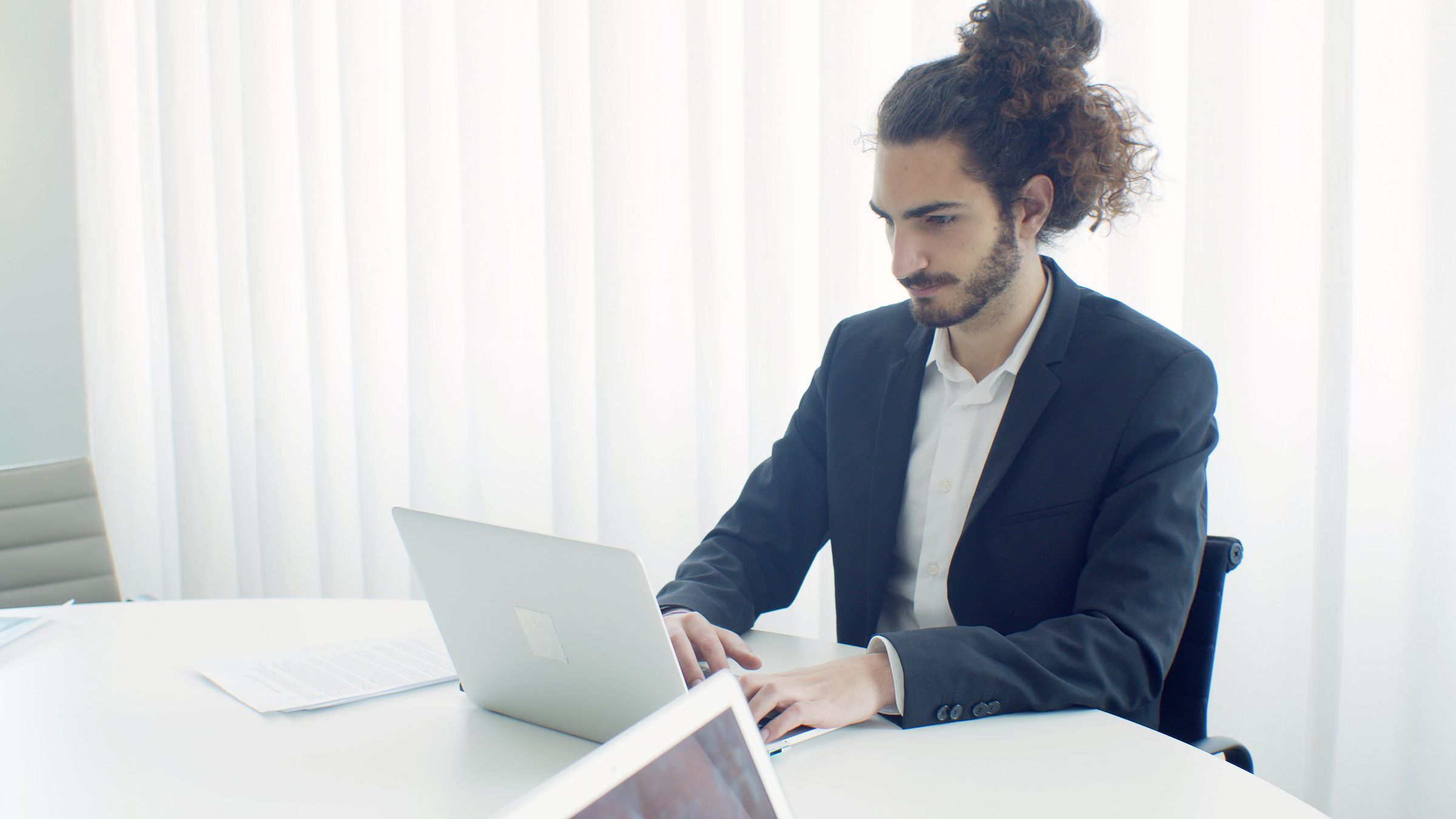 Professional connecting business tools on a laptop in a bright office