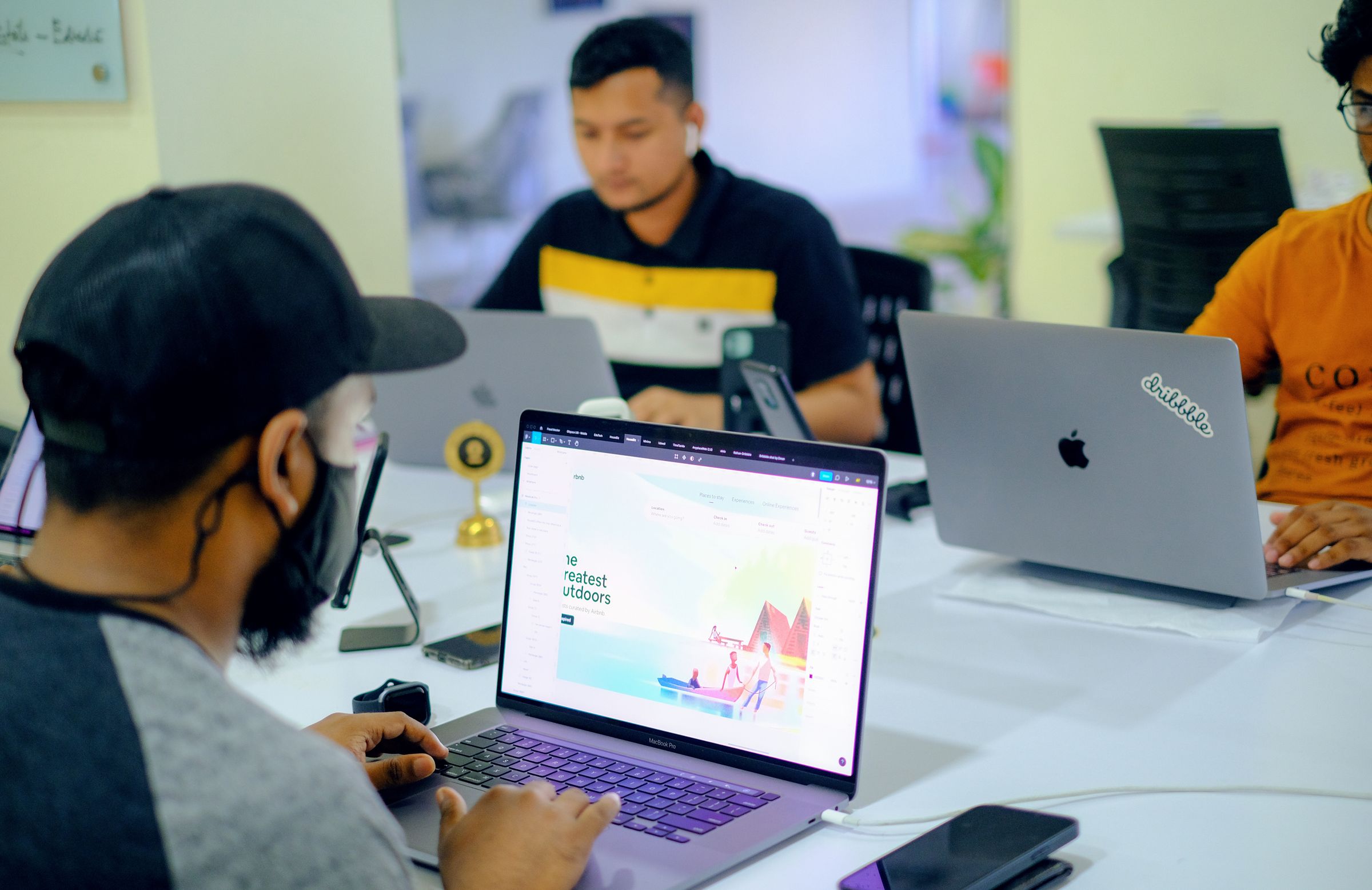 Performance team working on paid search campaigns across their laptops